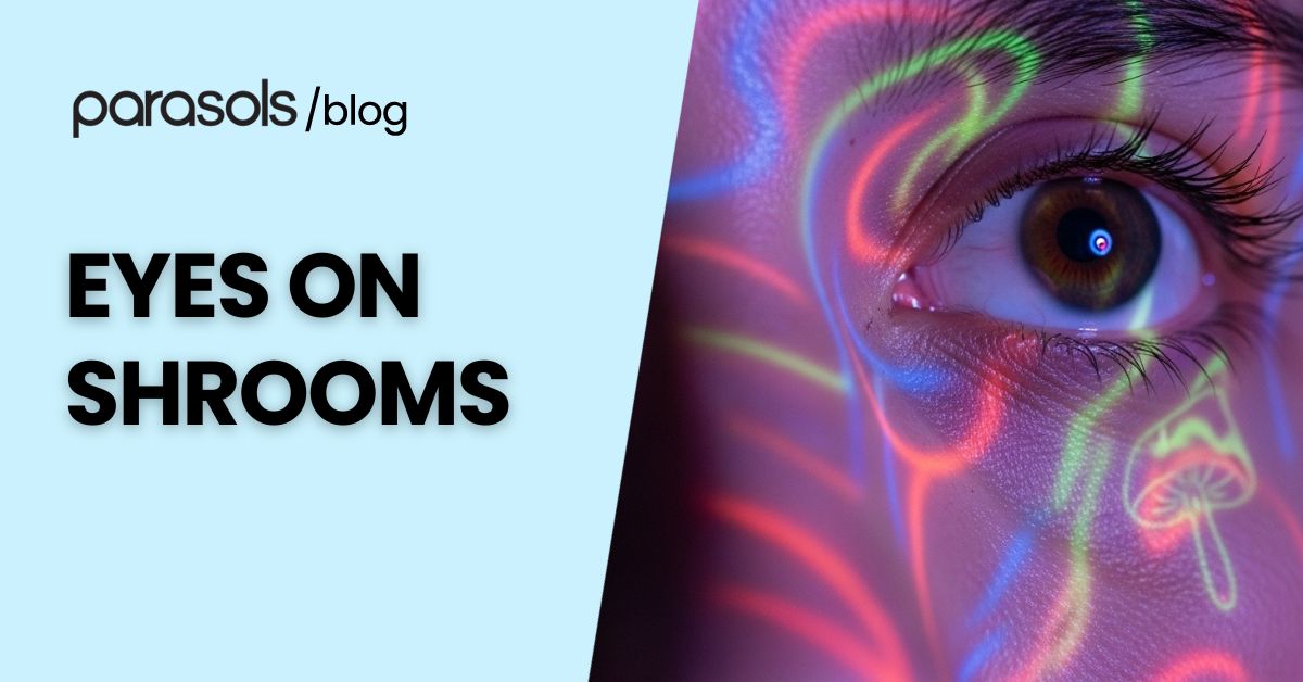 Close-up of a human eye with colorful psychedelic light patterns and mushroom shapes, representing eyes on shrooms and visual effects of psilocybin.